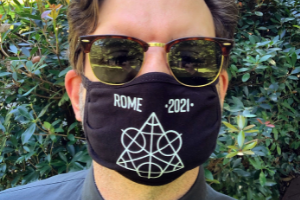 photo of man with sunglasses on and a face mask that says Rome 2021