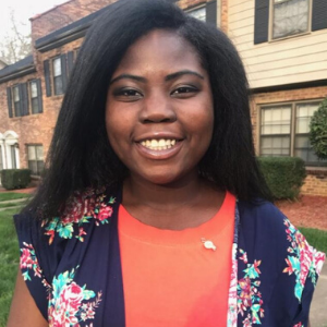 girl in front of her house smiling