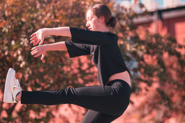 photo of recent graduate in a dance pose