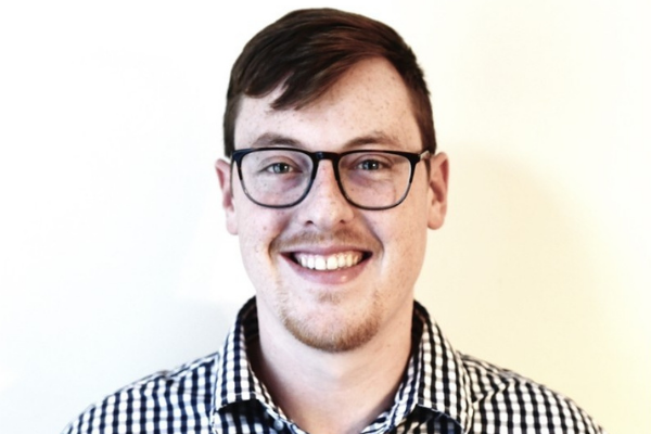 headshot of a man in glasses