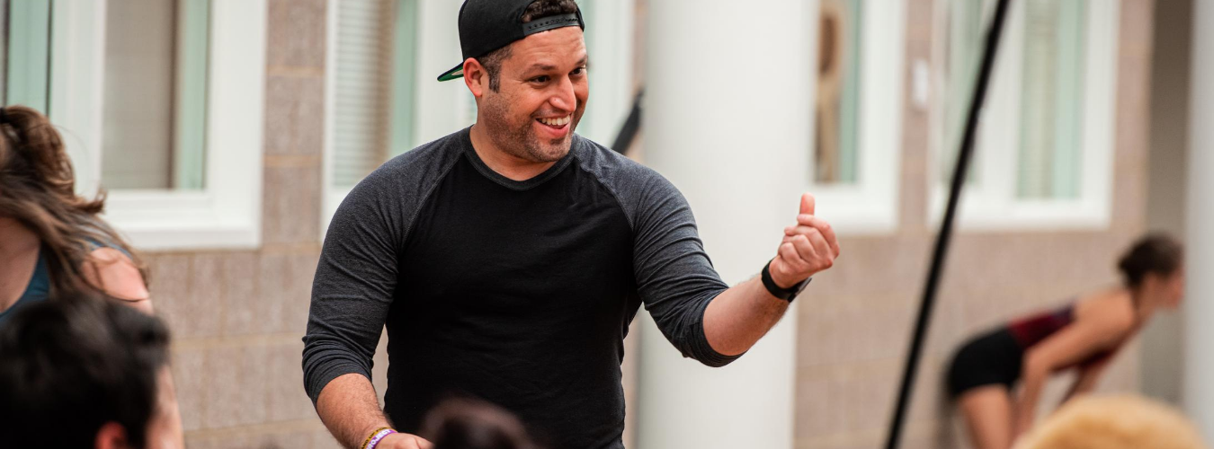 Carlos AlexisCruz giving a note to students in Storrs Salon