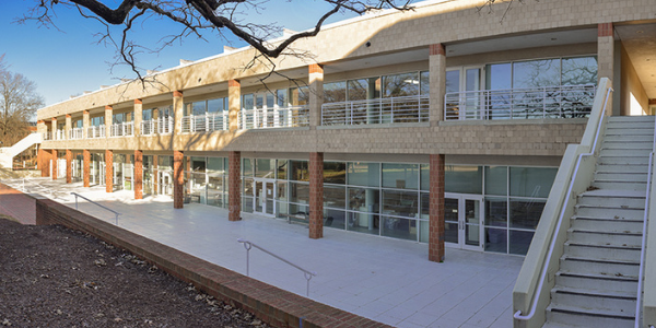 the outside of the Storrs architecture building; a two story rectangular building with stairs on either end