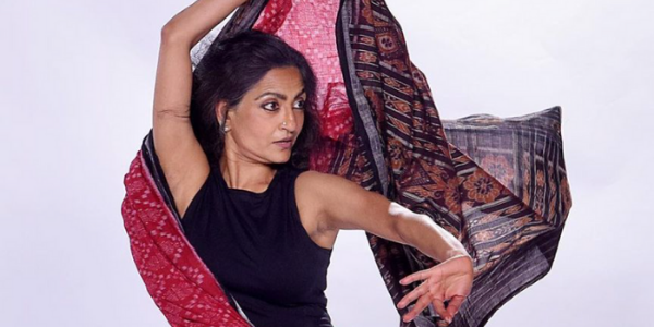 Indian woman with a scarf wrapped around her body, dancing