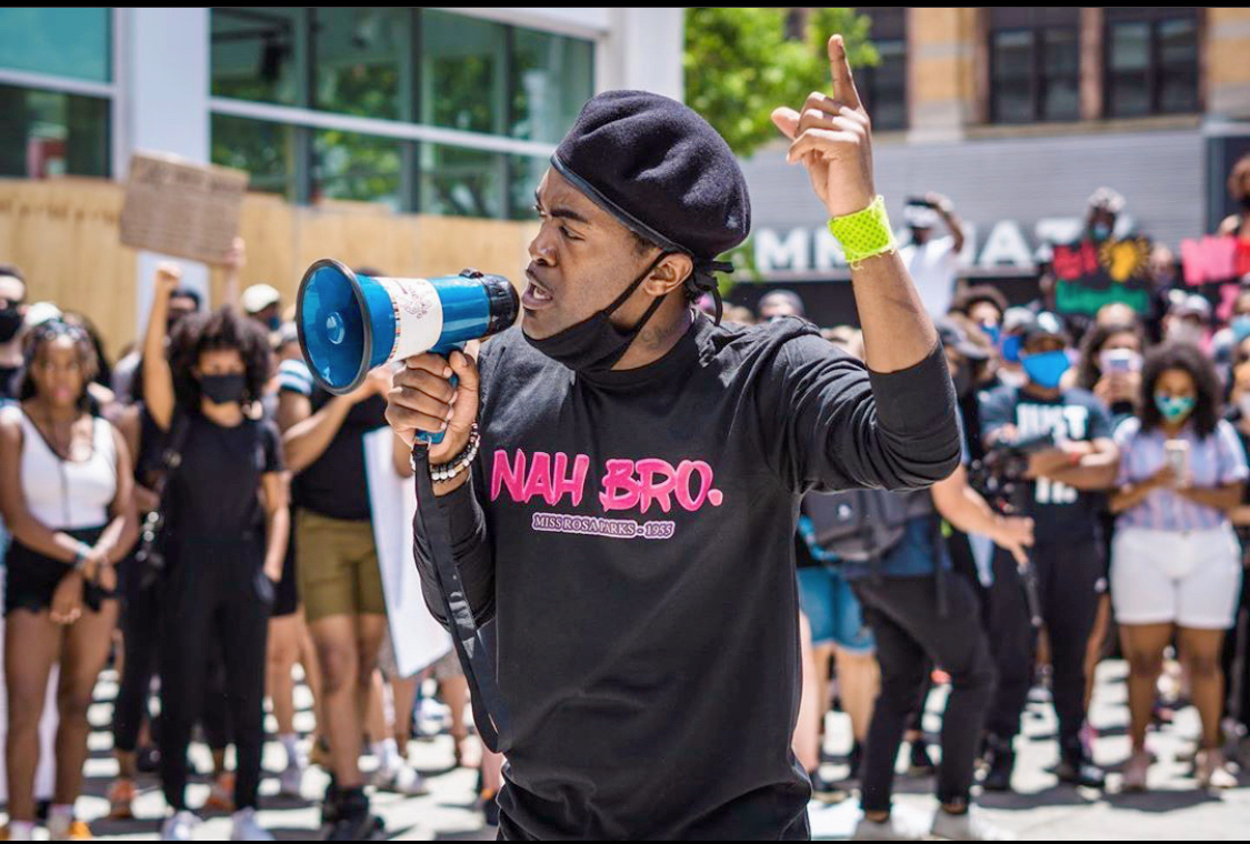 Sheen Jamal with a megaphone at the peaceful protest