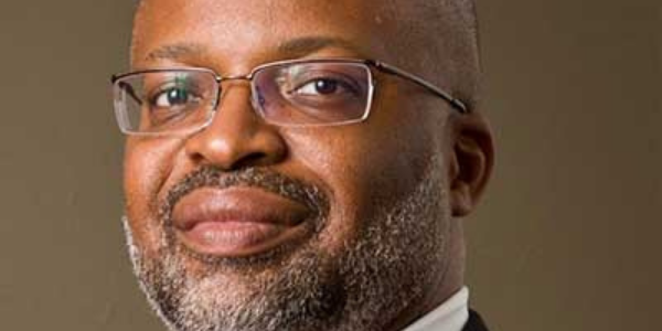 zoomed in headshot of a Black man with classes and a beard